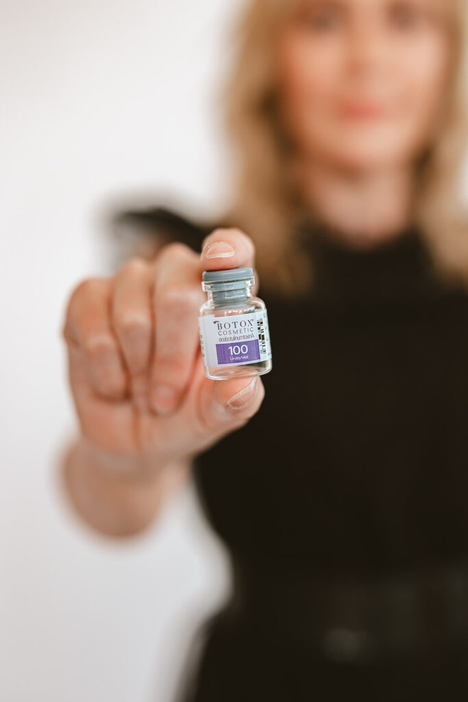 Image of the Vibrant Med Spa's owner, Erica Chowning, holding a vile of Botox in Louisville, Kentucky.