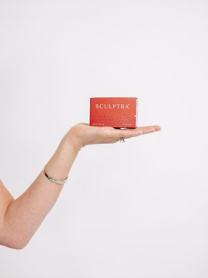 Sculptra Image of med spa owner holding a box of Sculptra which is a collagen injectable treatment available in louisville kentucky